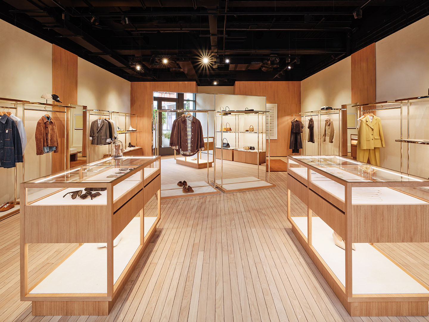Ami Paris boutique interior presenting designer clothing and accessories in a minimalist retail layout.