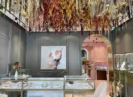 Anabela Chan boutique interior showcasing jewelry displays beneath a suspended dried-flower installation.