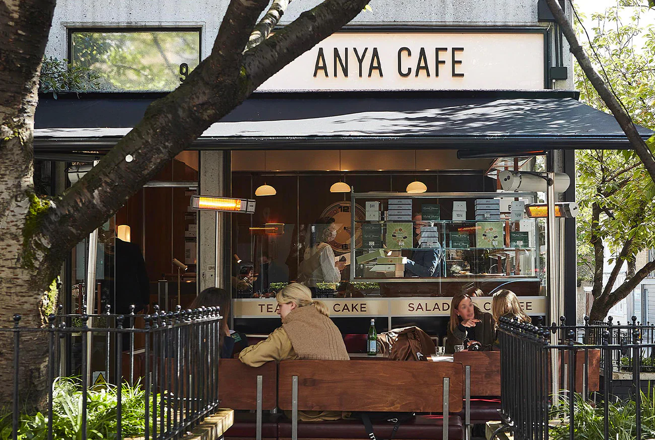 Anya Café storefront with outdoor seating and people dining