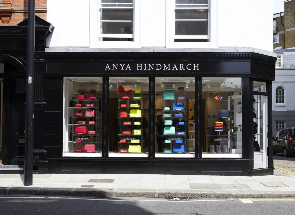 Anya Hindmarch storefront presenting labeled handbags as boutique merchandise