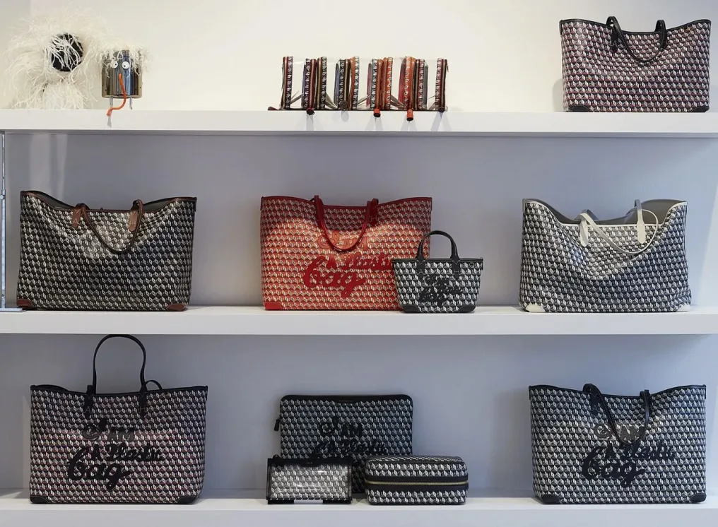 Retail display of patterned coated tote bags and matching pouches for sale