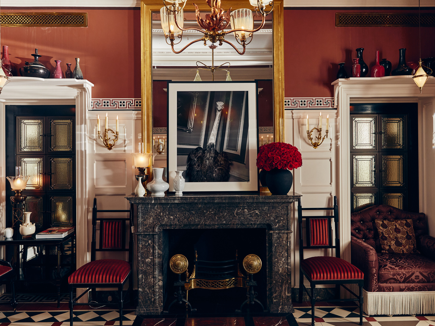 At Sloane sitting room centered on a decorative fireplace conveying an elegant Chelsea lounge for guests.