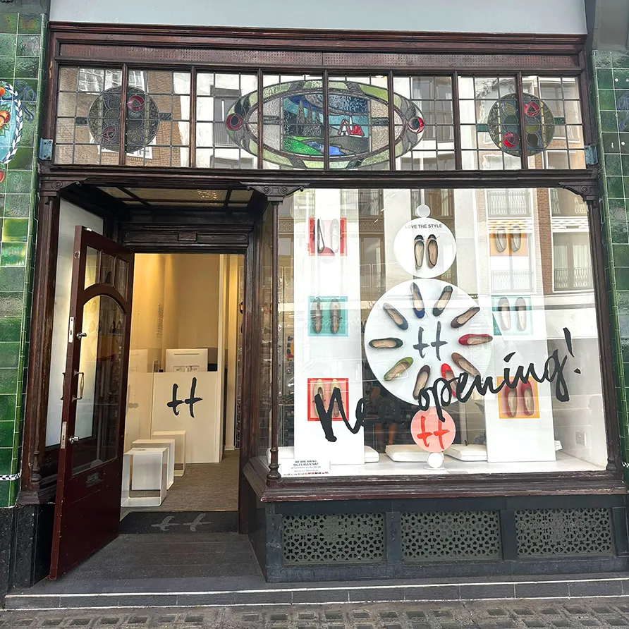 Ballarette shoe boutique storefront with window display announcing its opening