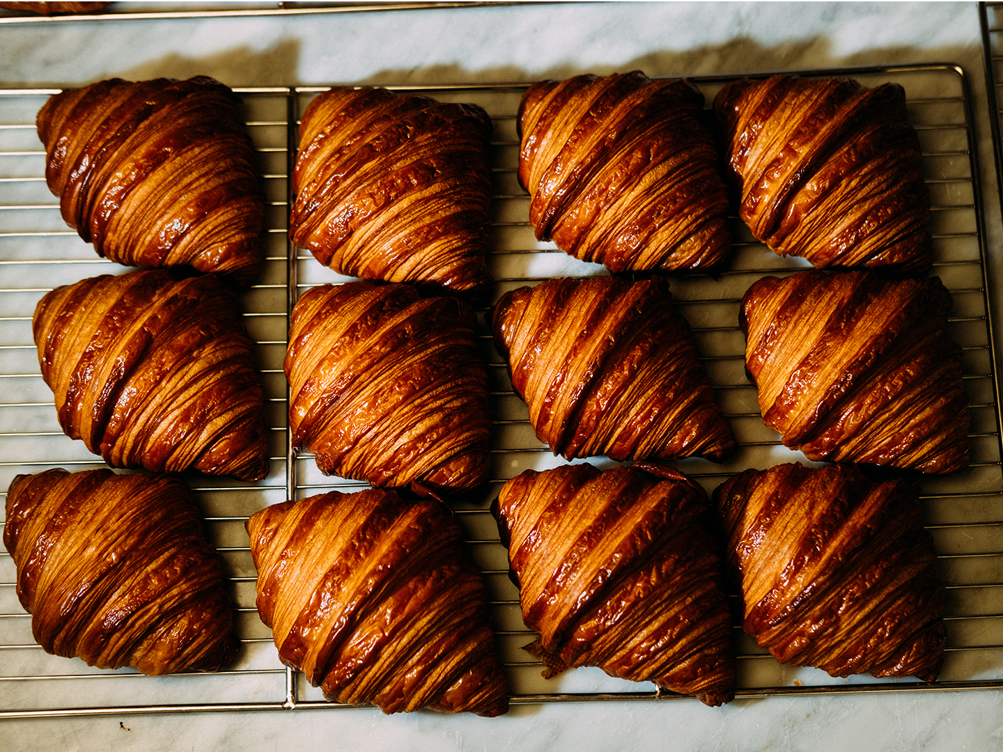 Freshly baked laminated pastries cooling on a wire rack at Cafe 1922, The Sloane Club.