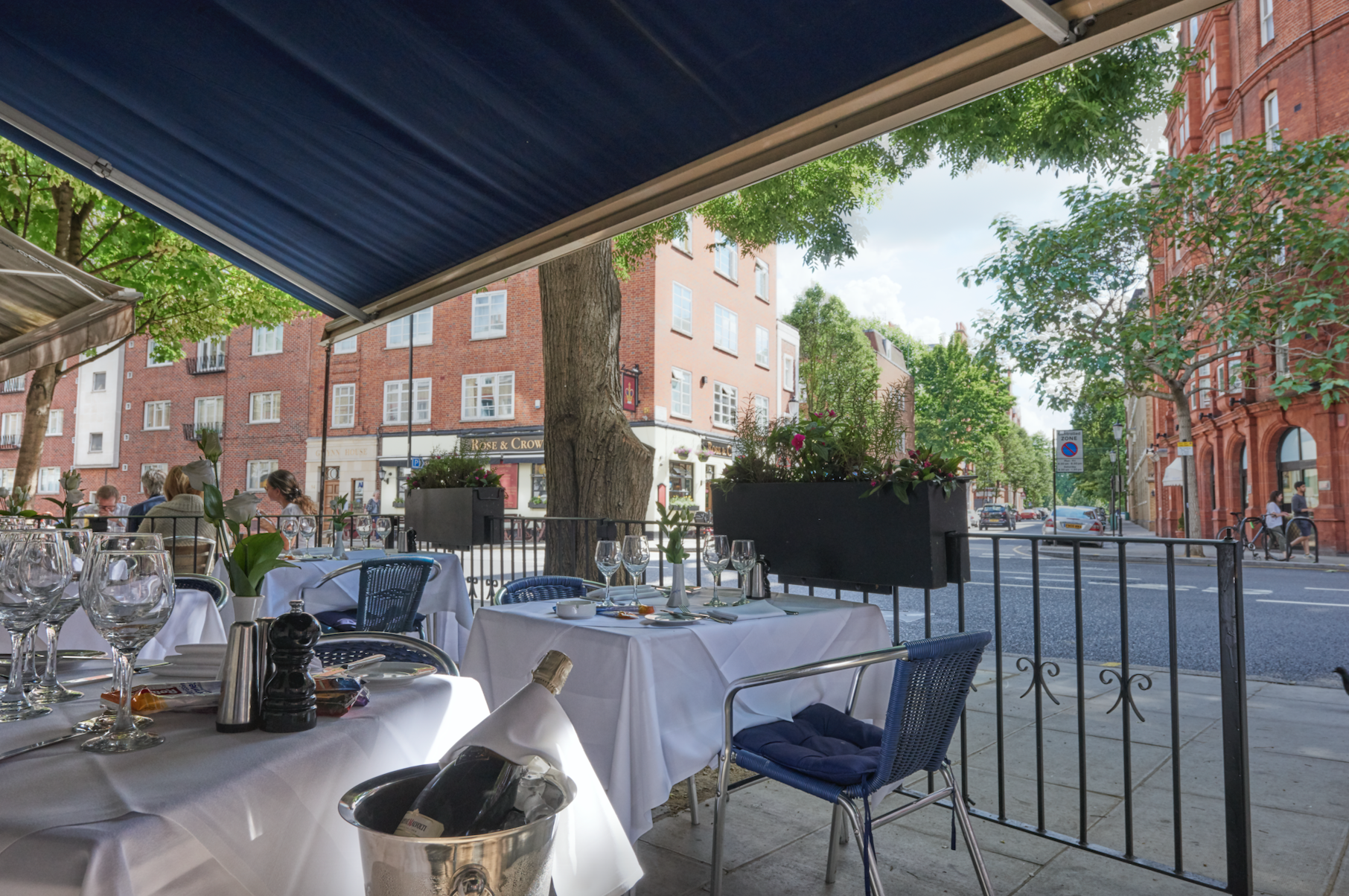 Outdoor dining area at Carrafini in Chelsea prepared for service.