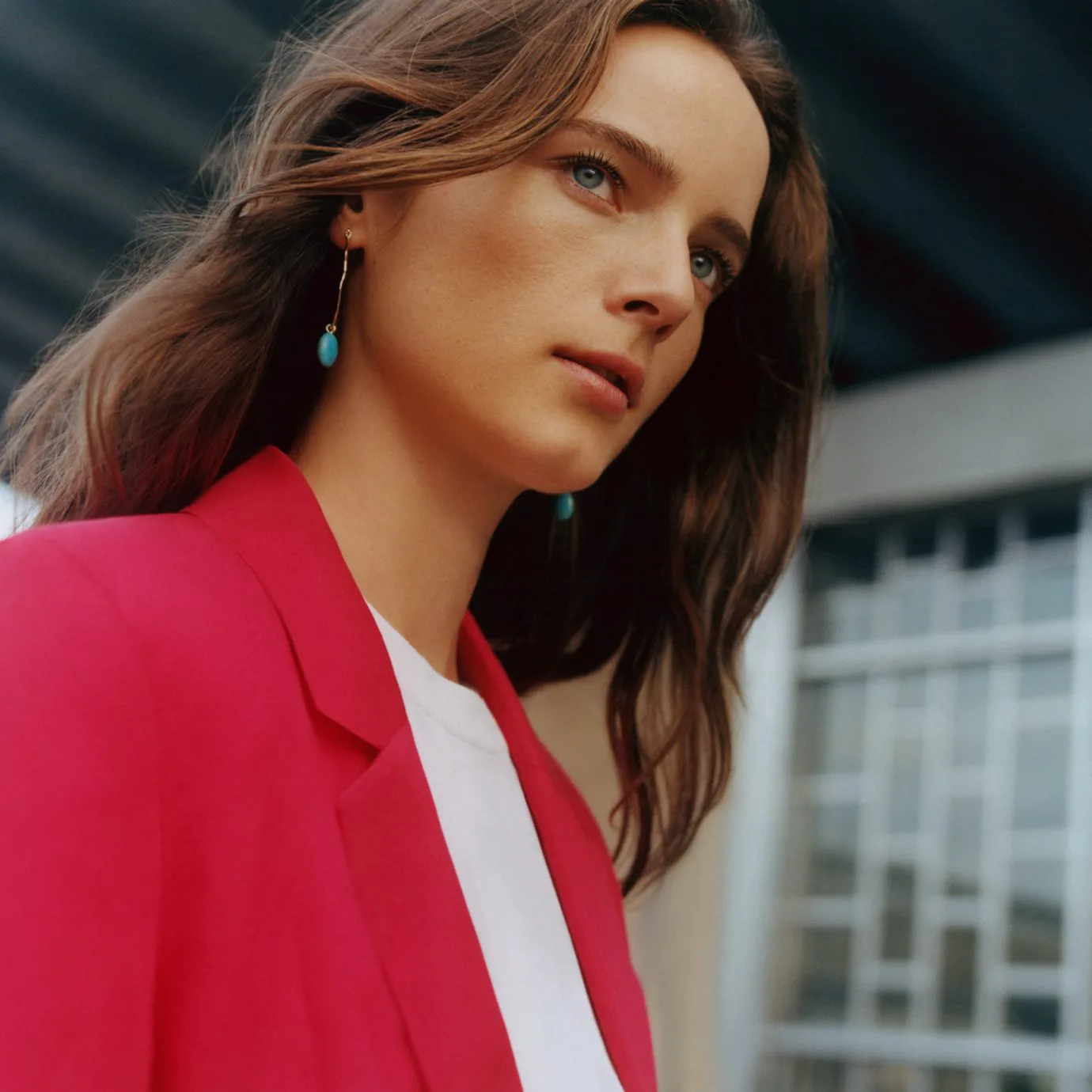 Model showcasing Claudie Pierlot blazer and turquoise drop earrings