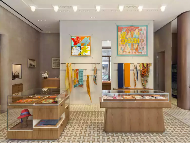 Hermès boutique interior presenting silk scarves and luxury accessories for sale
