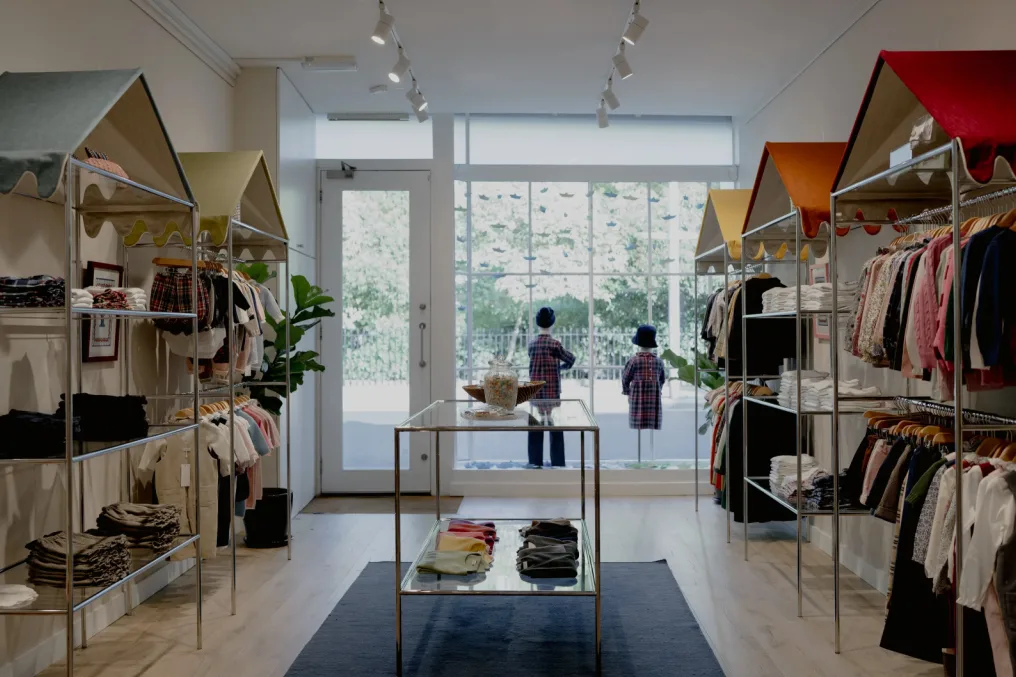 Il Porticciolo boutique interior with children's clothing and displays focused toward the storefront window.