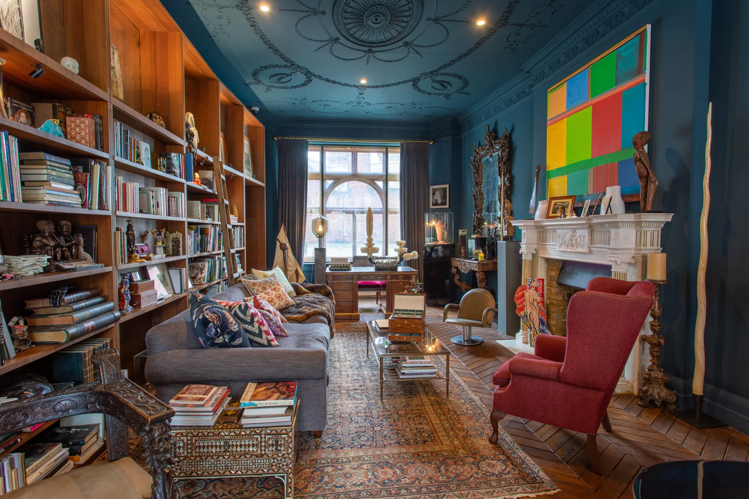 Eclectic, art-filled living room serving as a stylish sitting and reading space.