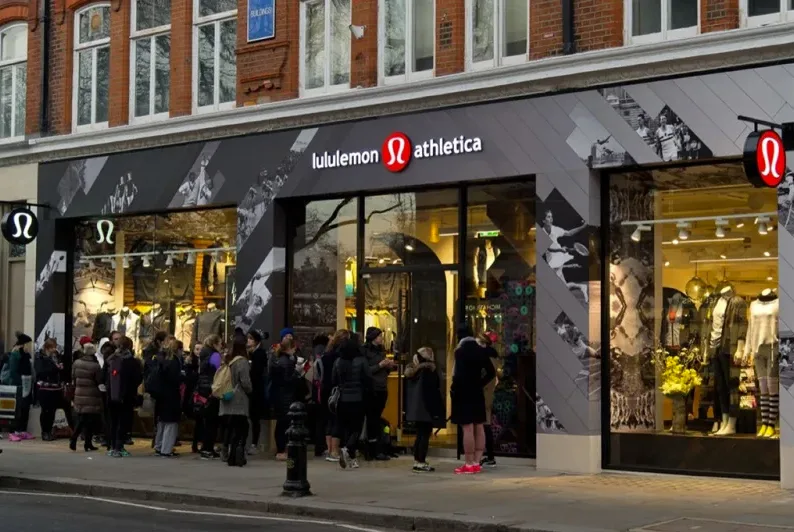 Lululemon Athletica storefront with customers queued outside