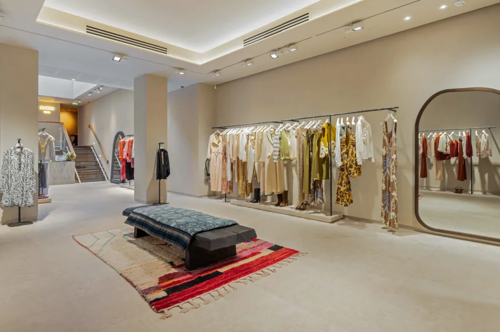 Upscale clothing boutique interior for displaying and trying on women's apparel.