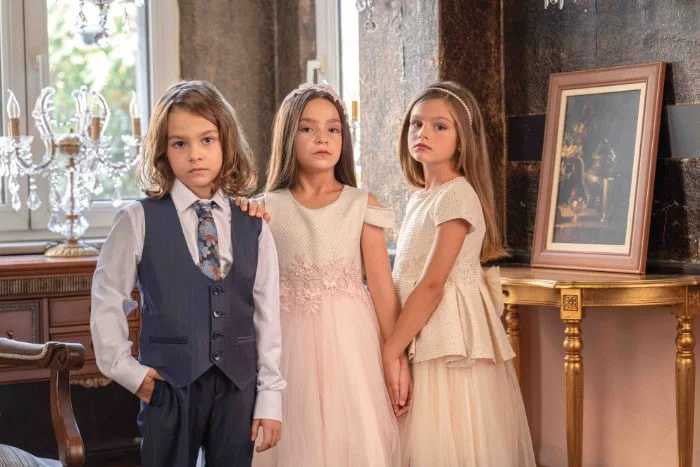 Three children posing for a formal portrait