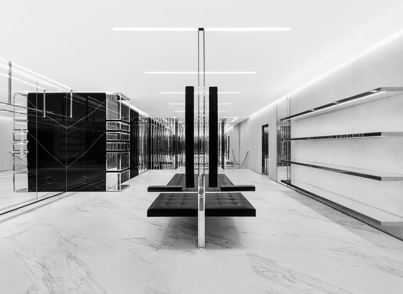 Saint Laurent boutique interior designed as a minimalist retail space for displaying luxury fashion.