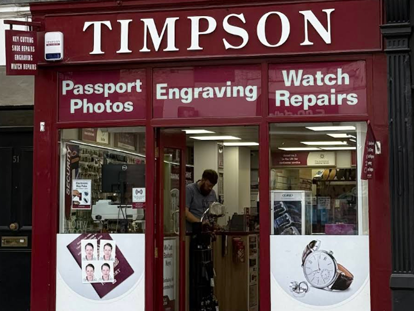 Timpson storefront offering passport photos, engraving and watch repairs