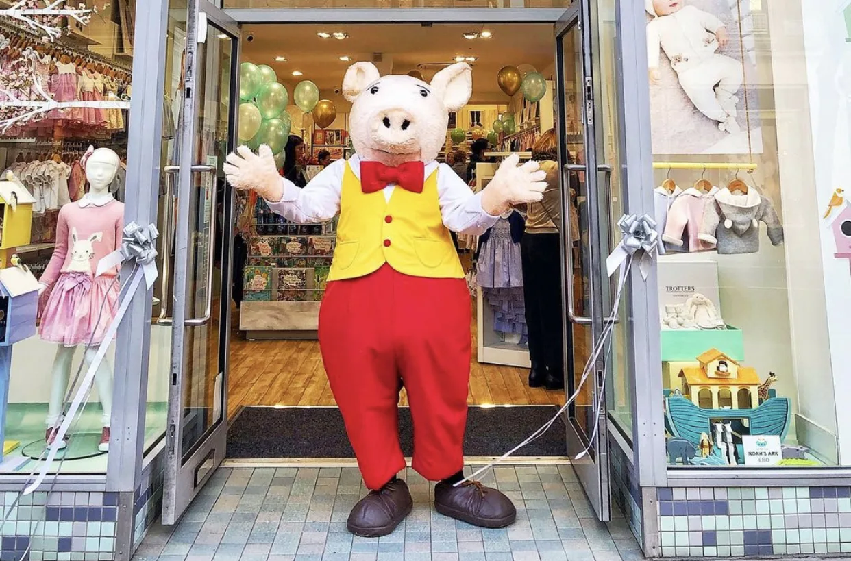 Trotters store mascot welcoming customers at the entrance