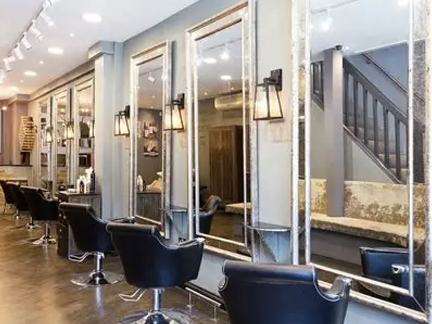 Vinny's Hair Salon interior with a row of styling stations for haircuts