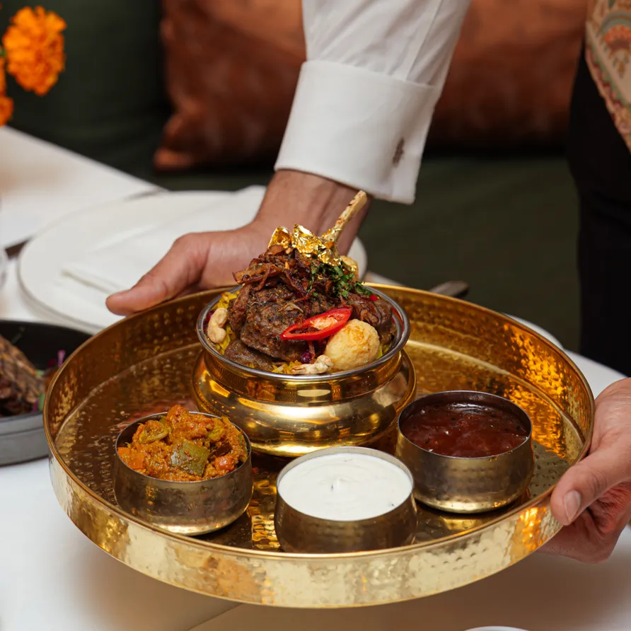 Festive Diwali lamb dish on a ceremonial brass tray at Jumeirah Carlton Tower