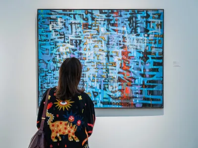 Visitor viewing an abstract painting at the British Art Fair.