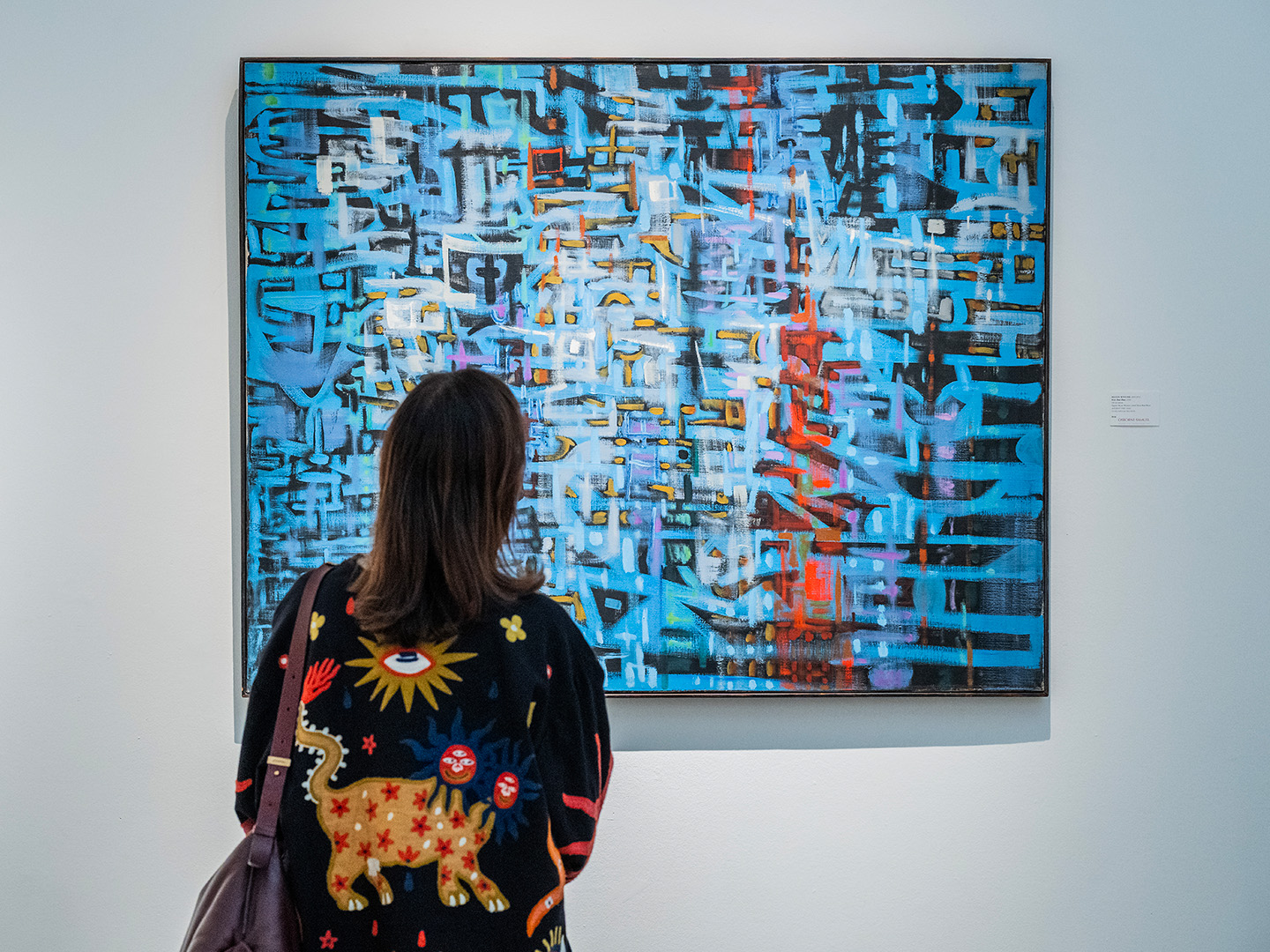 Visitor viewing an abstract painting at the British Art Fair.