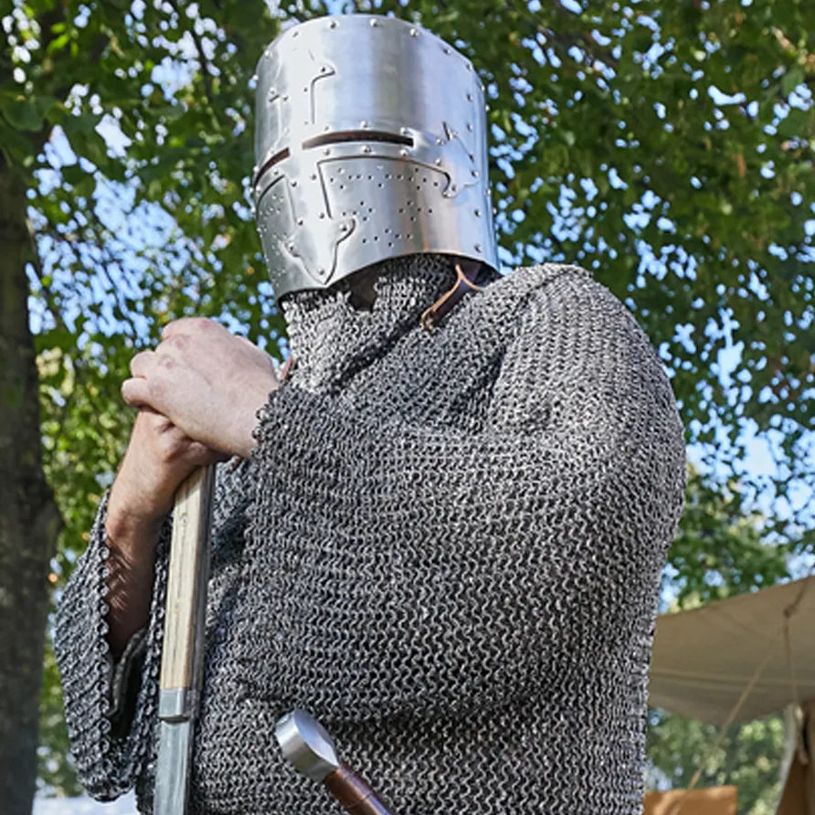 Medieval knight reenactor in chainmail and helmet at the Chelsea History Festival