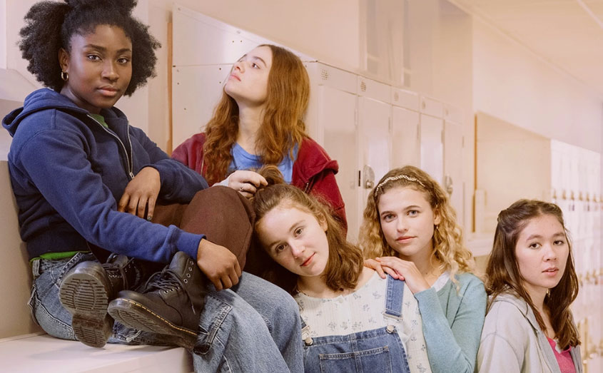 Teenage girls in a school hallway suggesting friendship