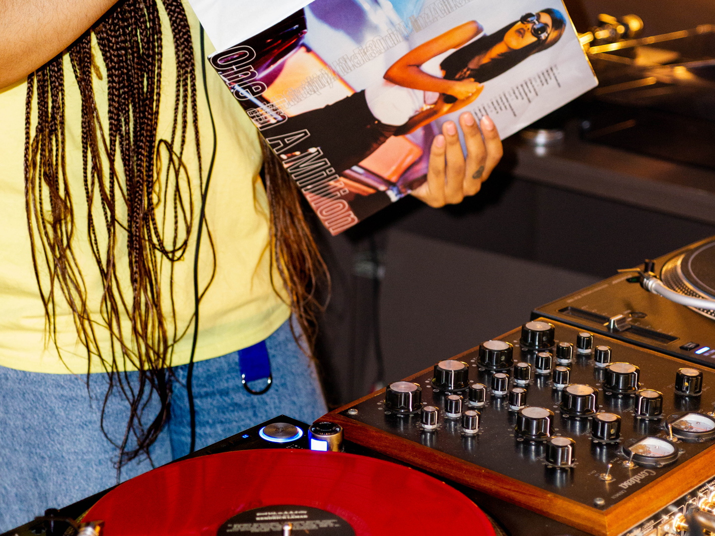 DJ performing with vinyl at a wine and art event