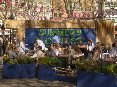 Outdoor dining area promoting Summer in Sloane Square event with people socializing