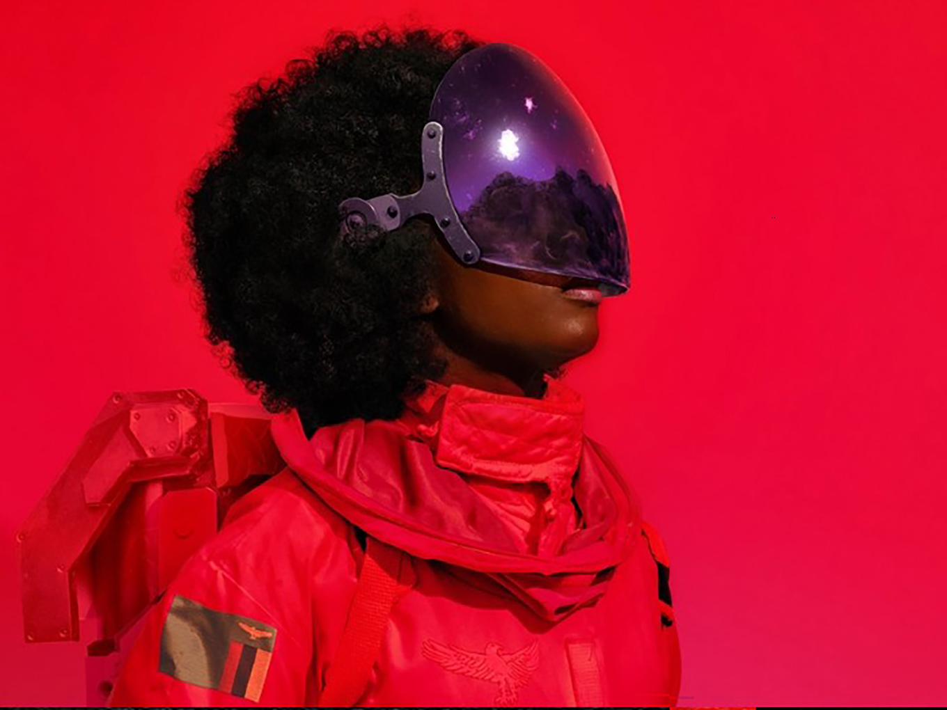 Actor in a futuristic astronaut costume wearing a mirrored visor for The Afronauts at the Royal Court Theatre.