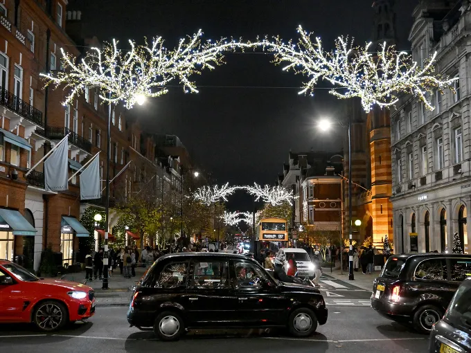 Sloane Street decorated for the Firefly Festive Forest with an illuminated canopy creating a festive evening shopping atmosphere