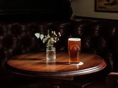 Pint of beer on a pub table promoting the £5 pints offer at The Trafalgar.