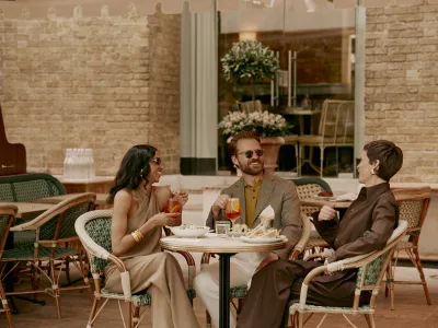 Friends enjoying alfresco dining and drinks at a Chelsea café