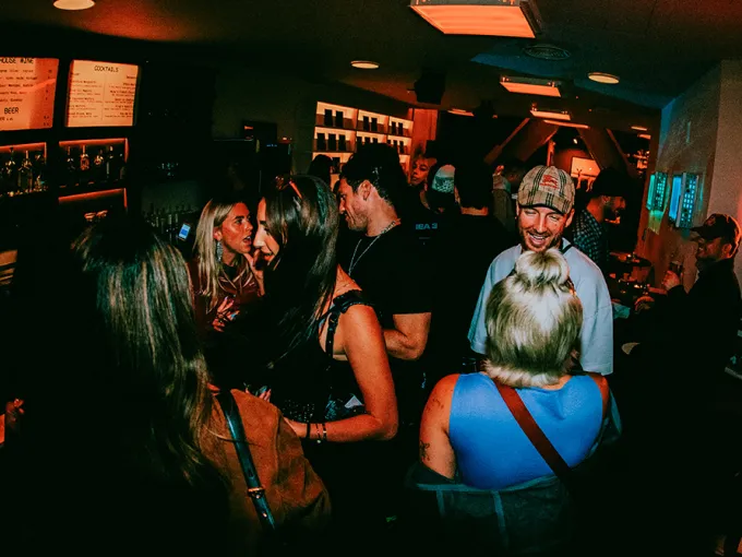 Crowd socializing at a lively Chelsea bar, illustrating the neighborhood’s nightlife and cultural scene.
