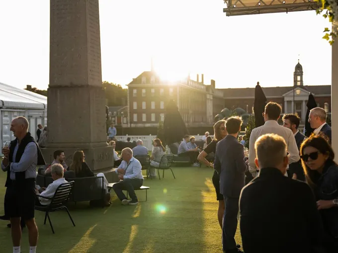 Rooftop social gathering at a Chelsea cultural venue at sunset