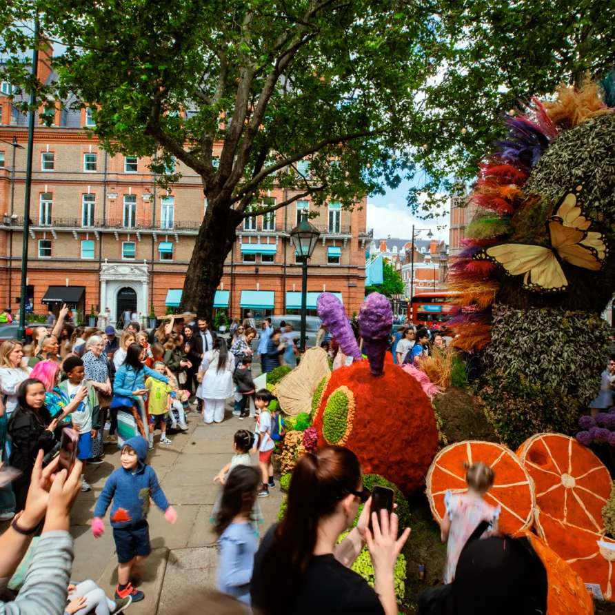 Crowd enjoying Chelsea in Bloom floral sculptures on Sloane Square.