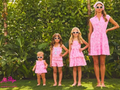 Family modeling coordinated pink dresses and sunglasses for a Janie & Jack x Hatch family-style collection.
