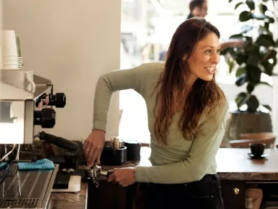 Barista preparing espresso behind the counter at a Chelsea café.