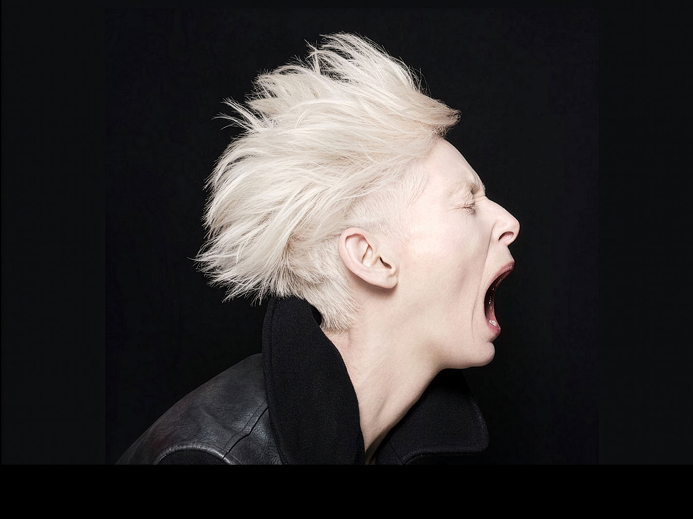 Performer mid-yell conveying dramatic intensity and theatricality